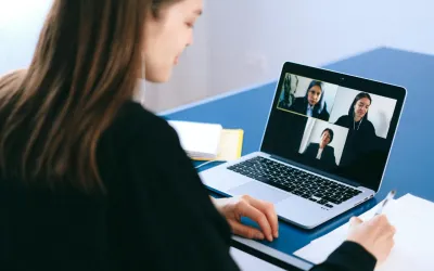 One individual using web meeting software with three others on screen